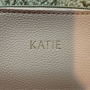 This is a small mauve pink handbag with the name Katie on it